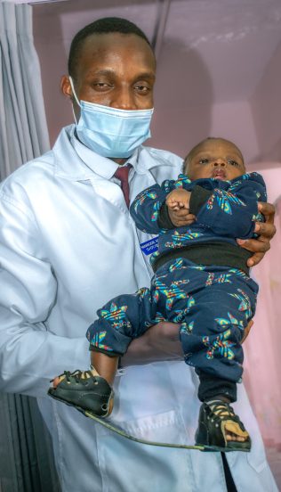 Mum hugs child after completing clubfoot tenotomy treatment CCK Clubfoot Care for Kenya Hope Walks Programme Treating Clubfoot-4